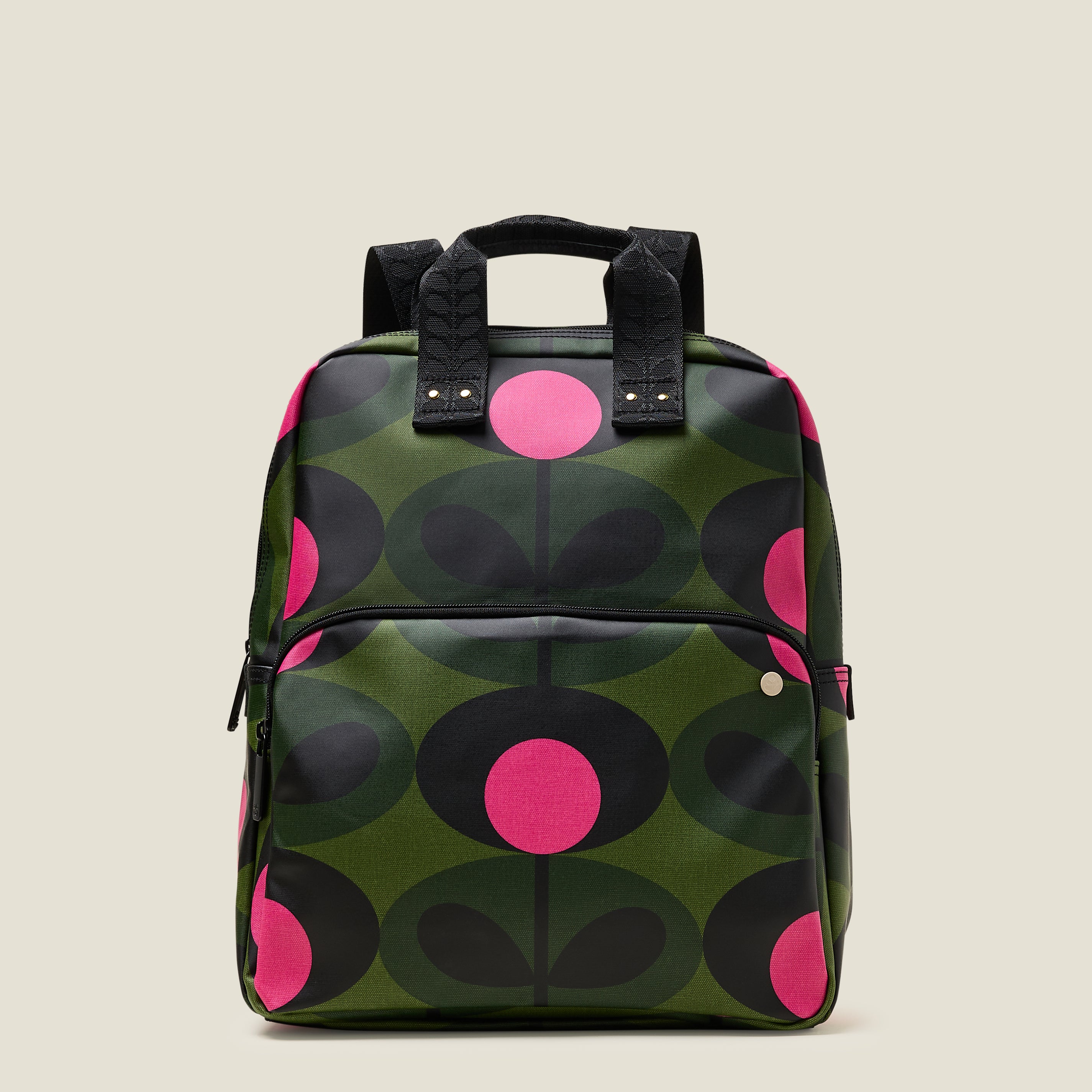 Front view of the Lotta Backpack in a green stem print with bright pink dots, featuring a zipped front pocket branded grab handles.