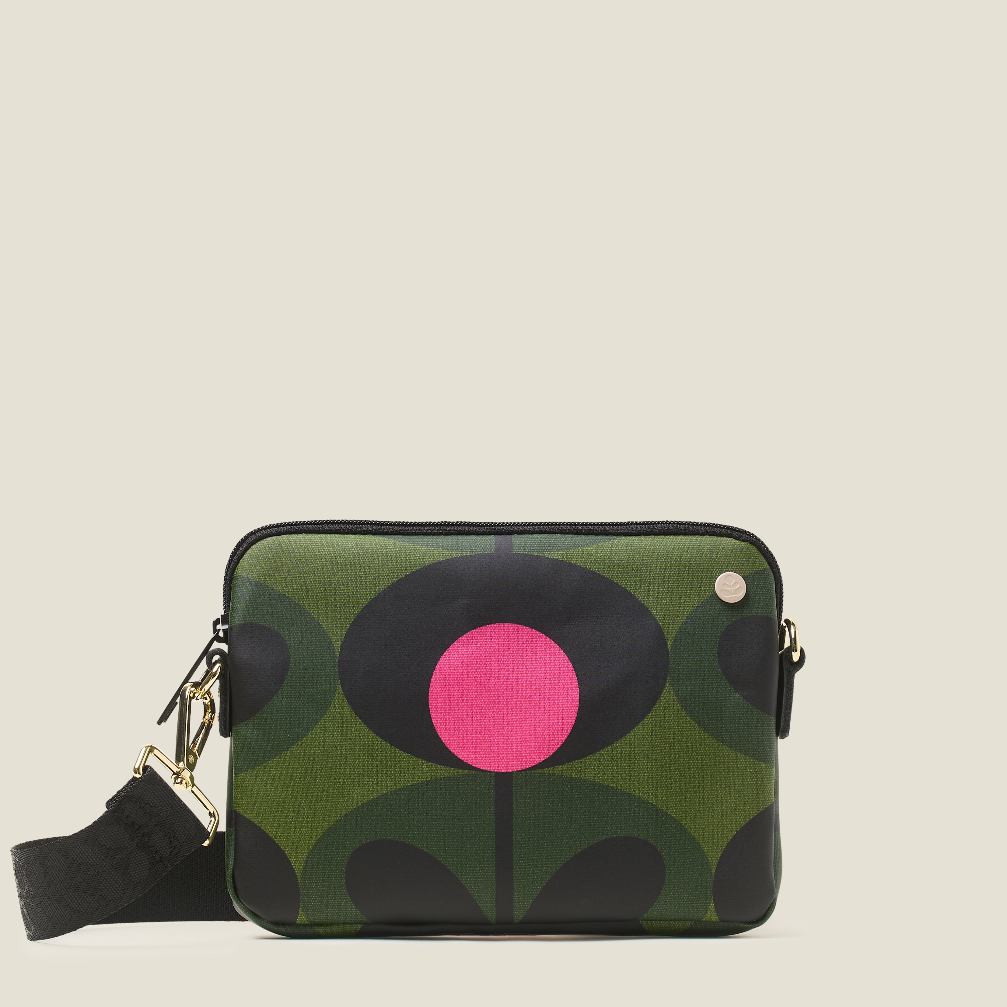 Front view of green patterned slim crossbody bag with a pink flower, zip closure and crossbody strap.