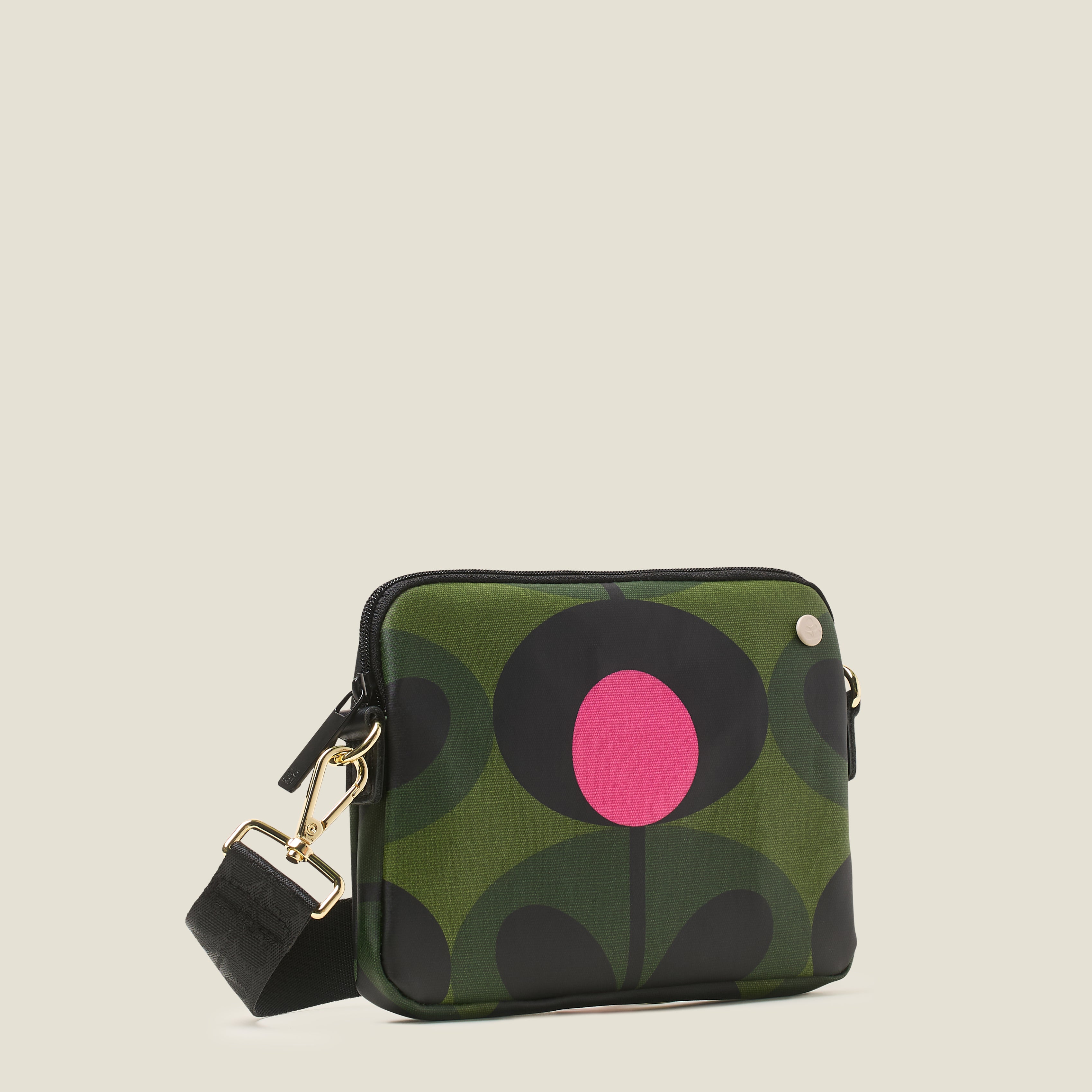 Side view of green patterned slim crossbody bag with a pink flower, zip closure and crossbody strap.