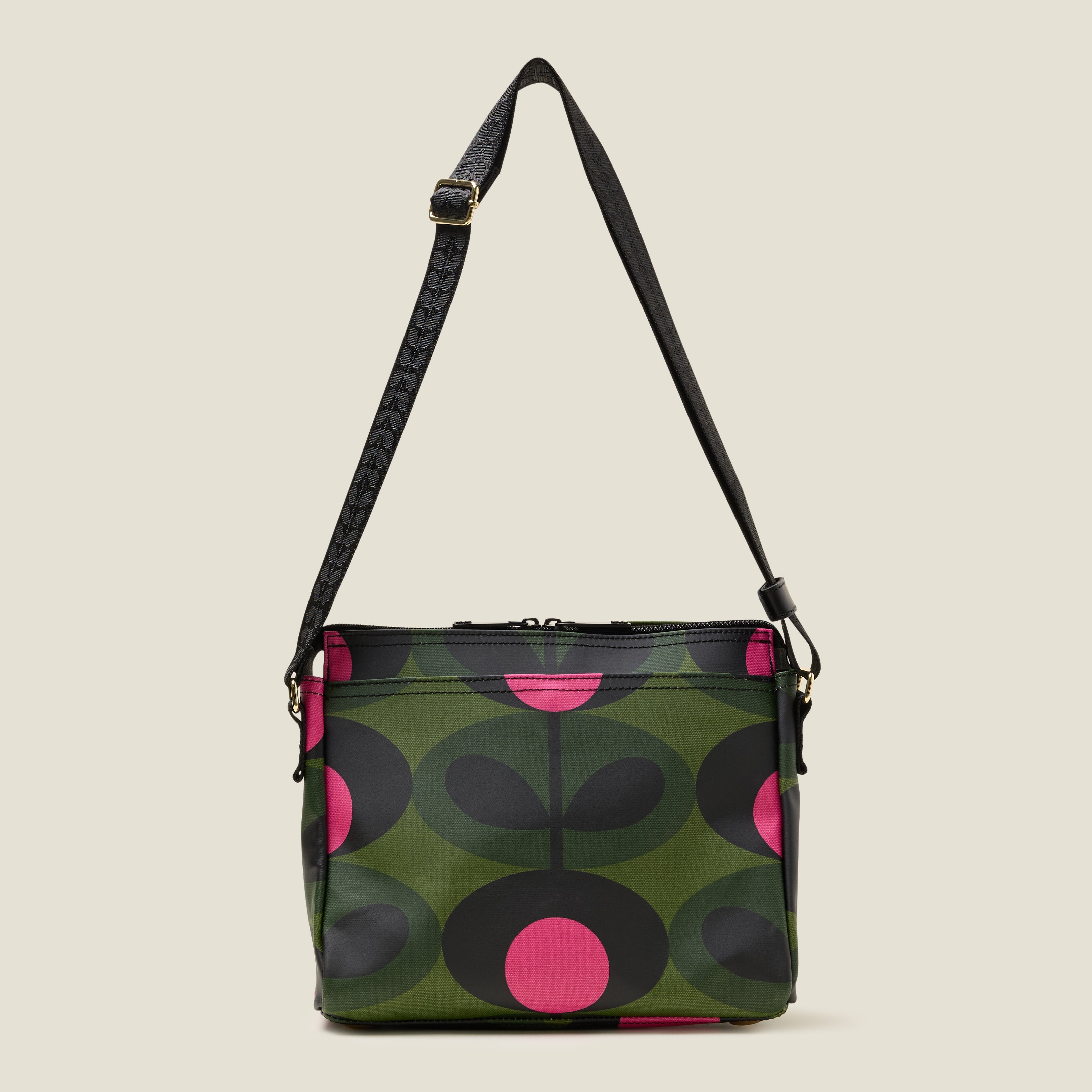 The forest green Fielder Crossbody bag front view with slip pocket, zip closure and strap at full length.
