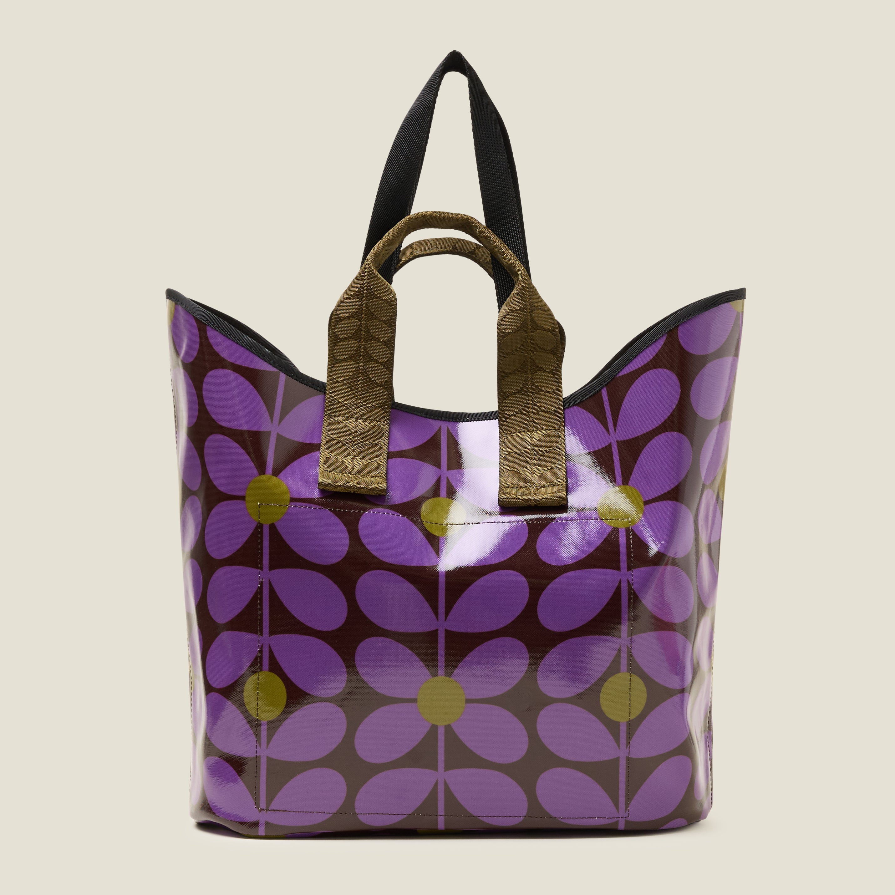 Back view of large patterned tote bag with purple, brown and green floral stem print featuring two short grab handles.