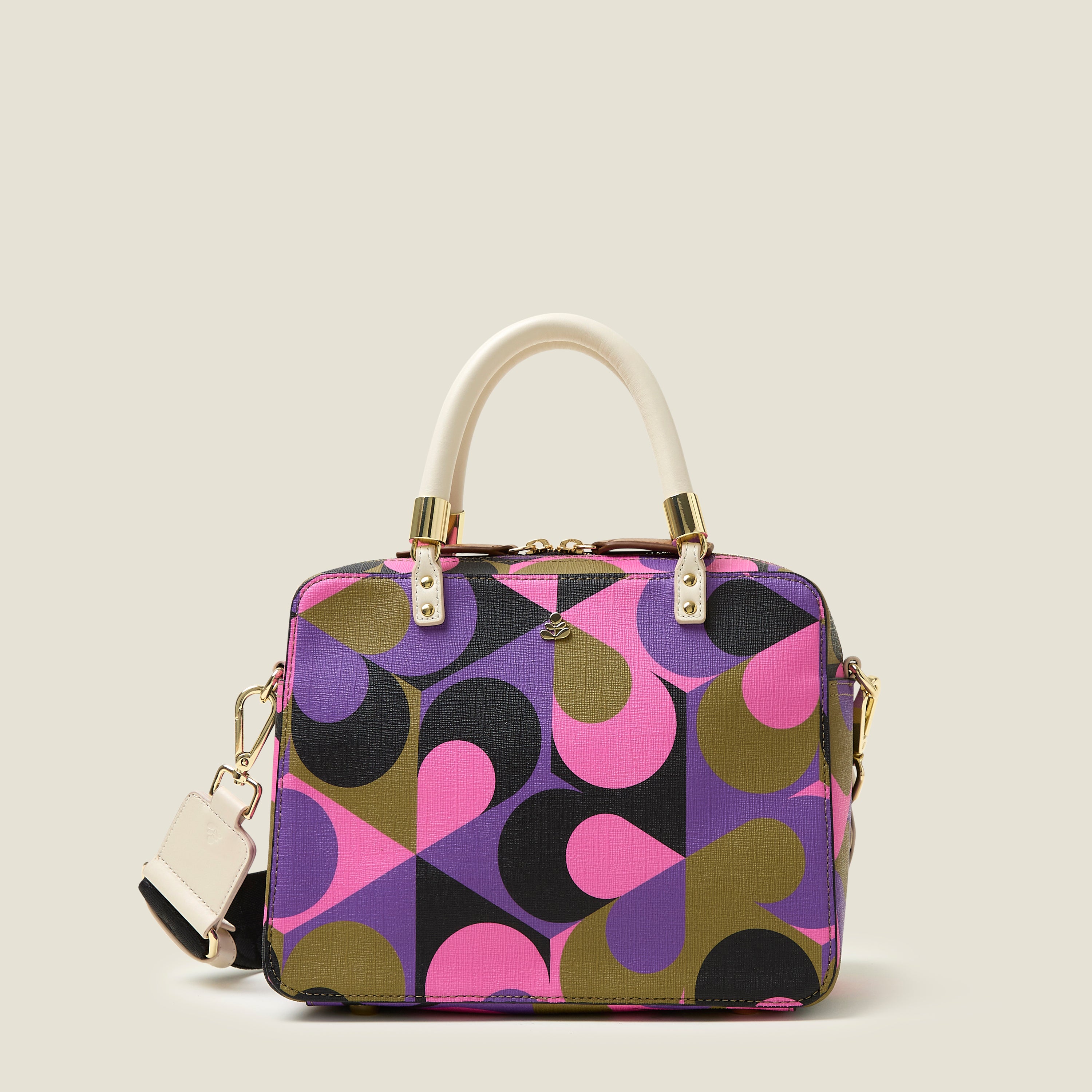 A medium-sized handbag with a geometric pattern in shades of violet, pink, and khaki, featuring white leather handles and gold-colored hardware.