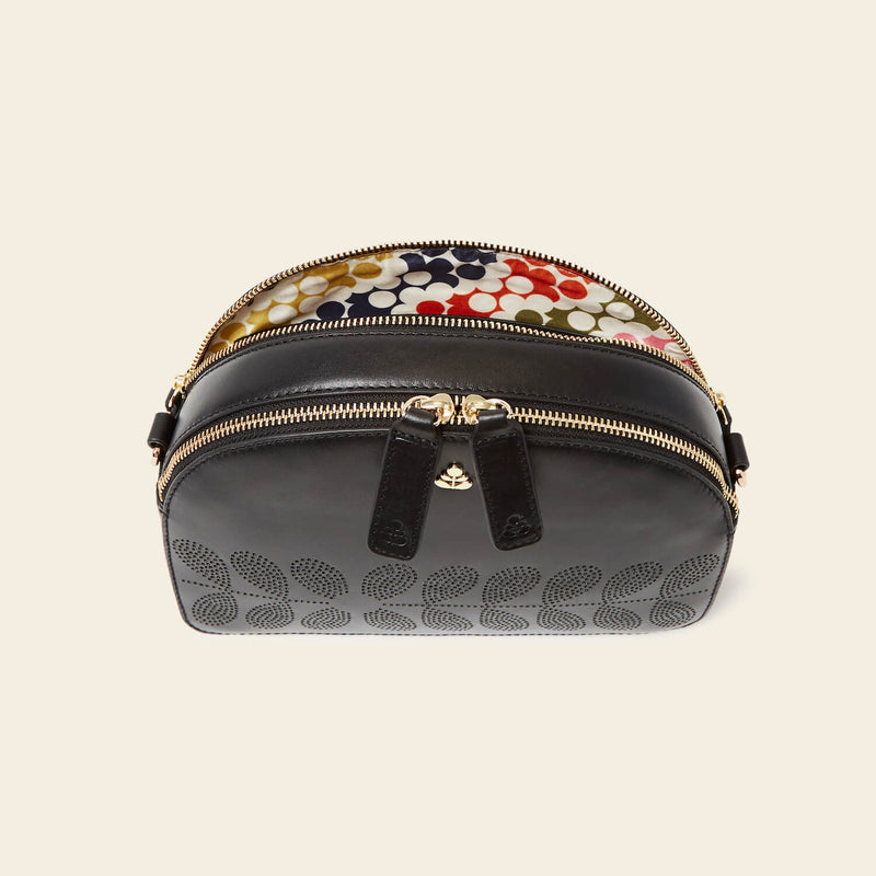 Luna Crossbody in Black Punched Flower pattern by Orla Kiely