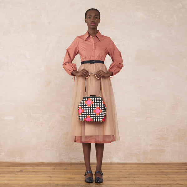 Model wearing the Jenny D Handbag in Fuchsia Flower Polka Dot pattern by Orla Kiely