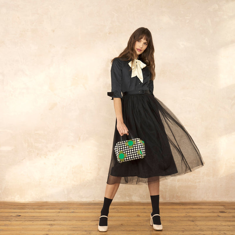 Model wearing the Concertina Crossbody Tote Bag in Jewel Flower Polka Dot pattern by Orla Kiely