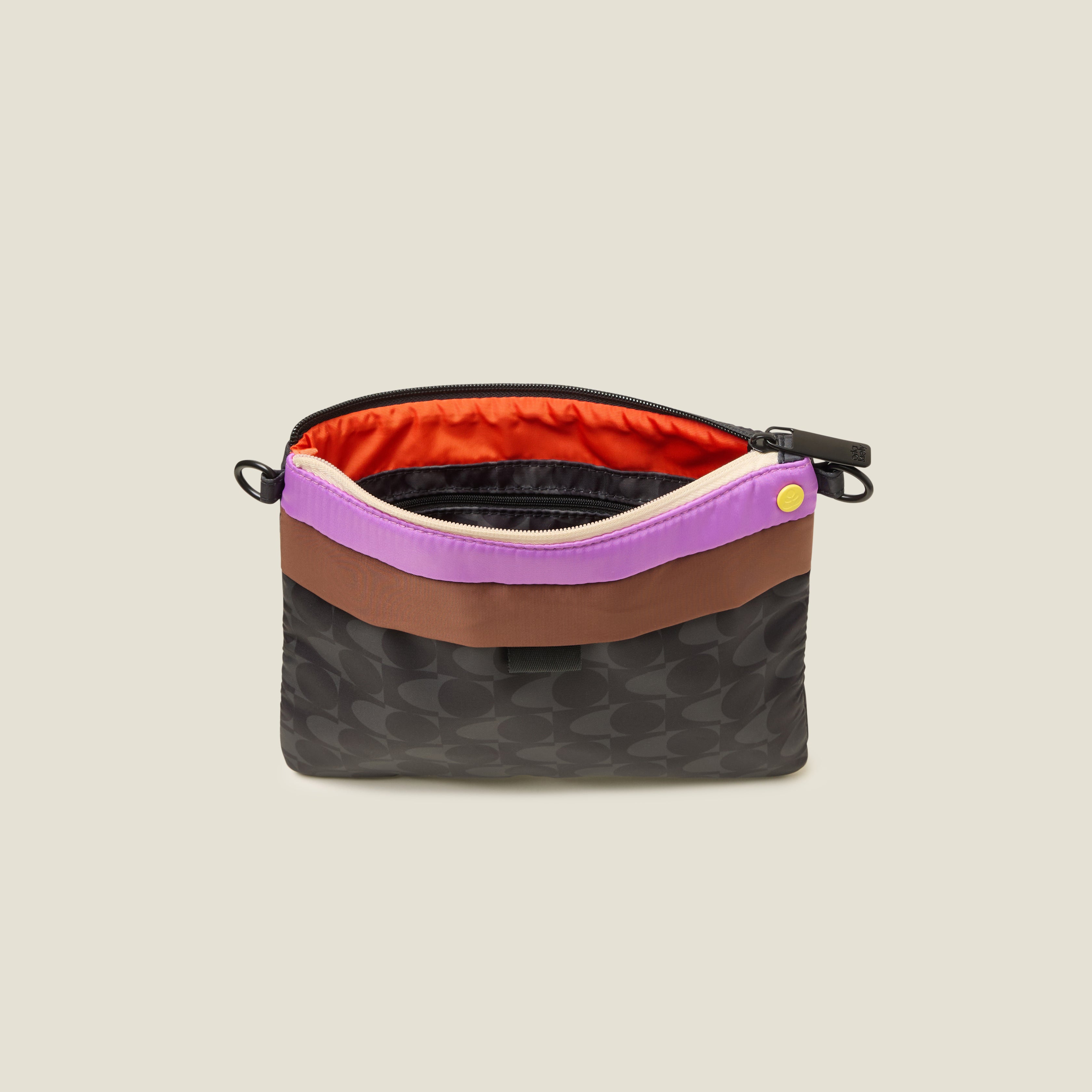 Multicolored crossbody bag with strap removed so can be used as a clutch bag with zipper closure with contrast orange lining