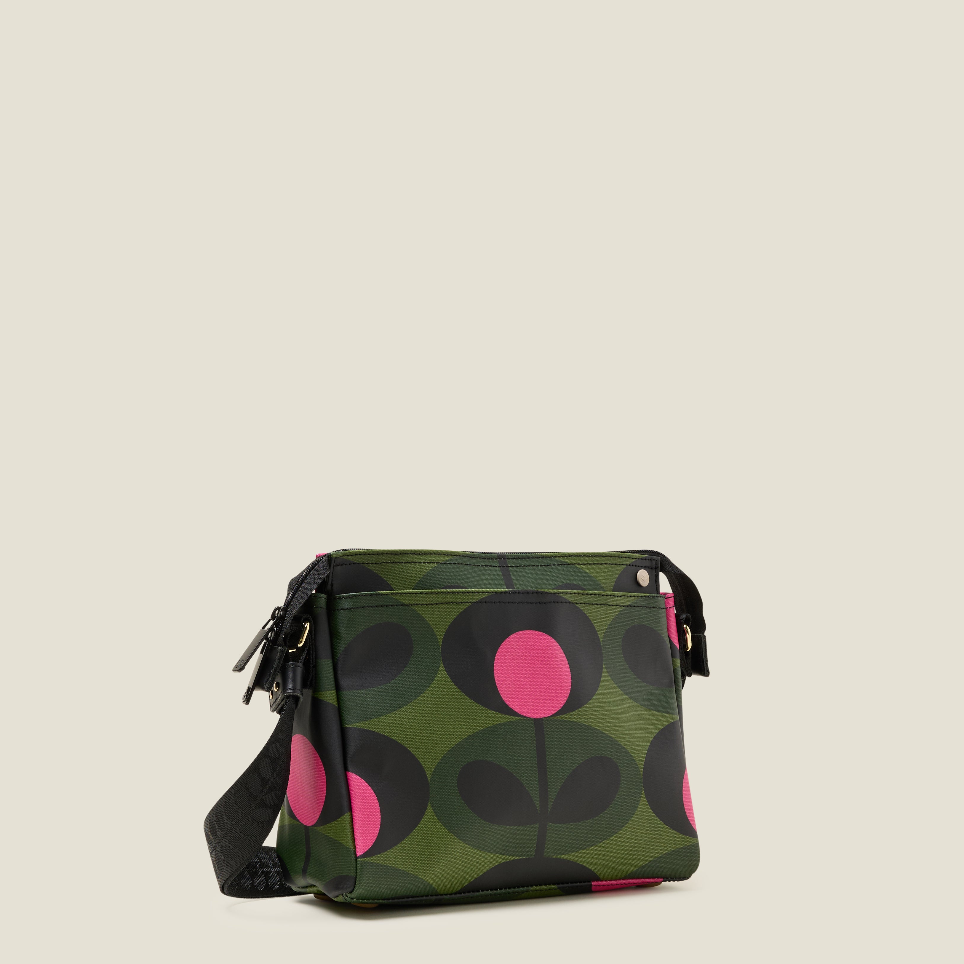 The forest green Fielder Crossbody bag side view with slip pocket and zip closure. 