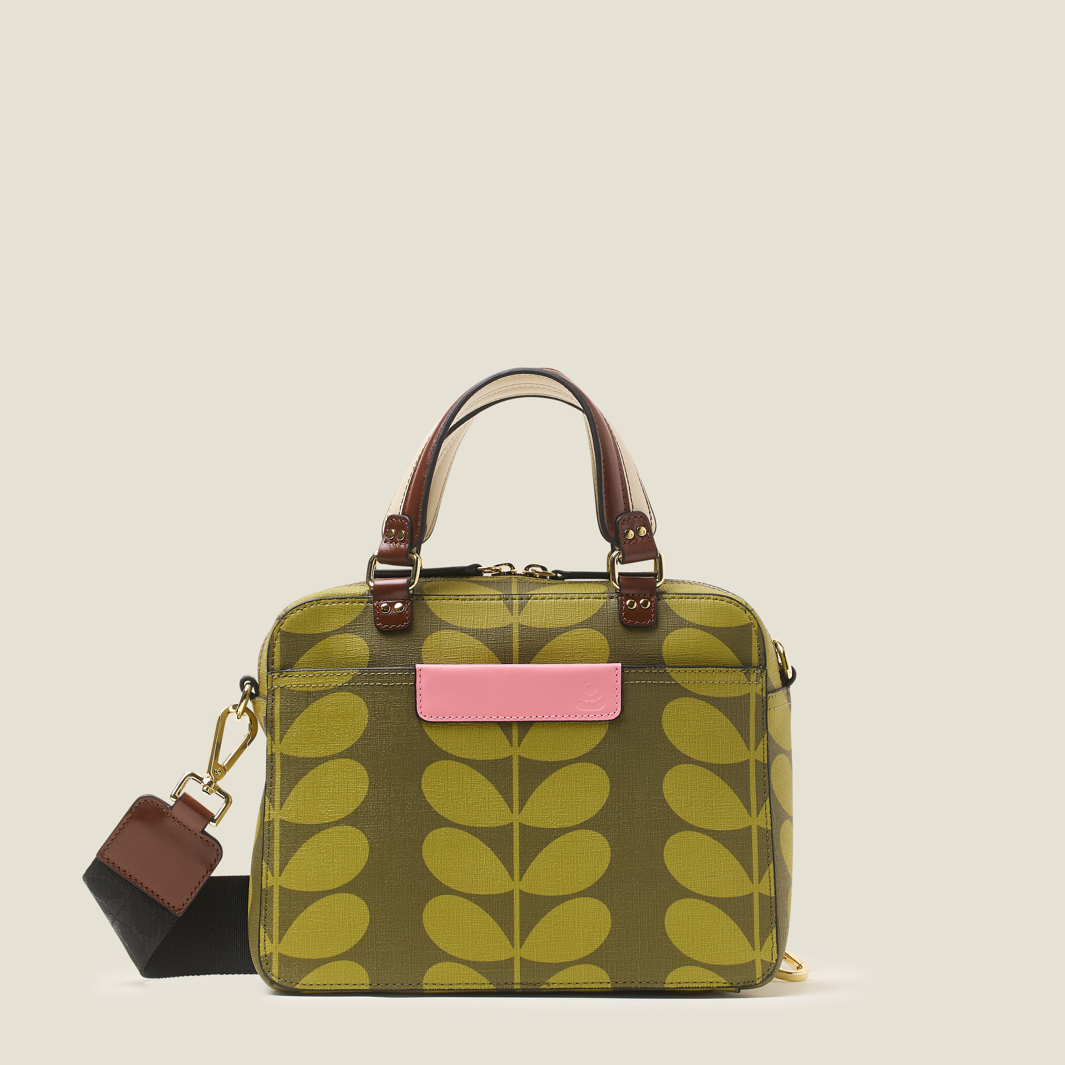 Front view of a medium square handbag with green leaf pattern, featuring leather grab handles and pink branding.