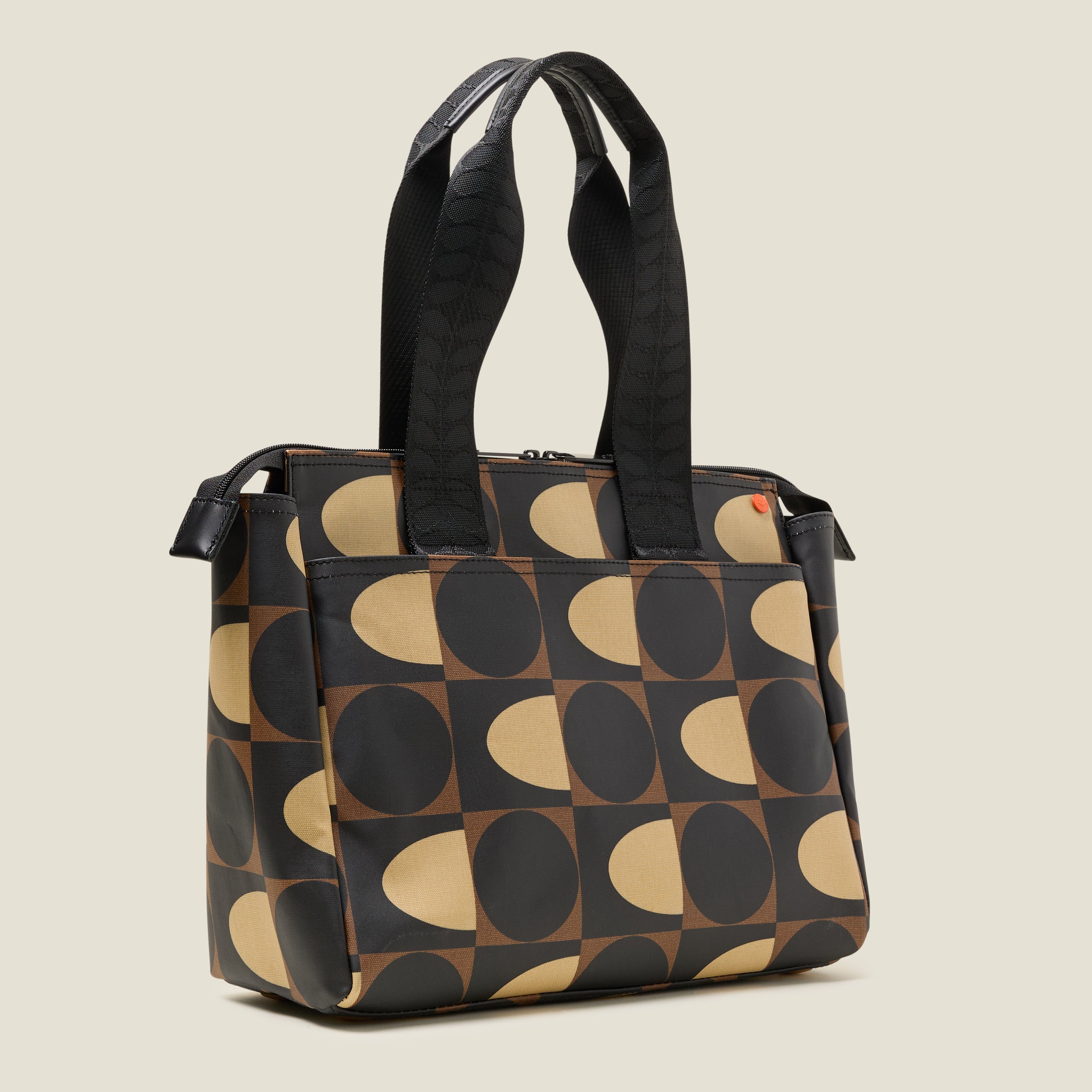 Side view of a brown, black and cream patterned tote bag with branded grab handles
