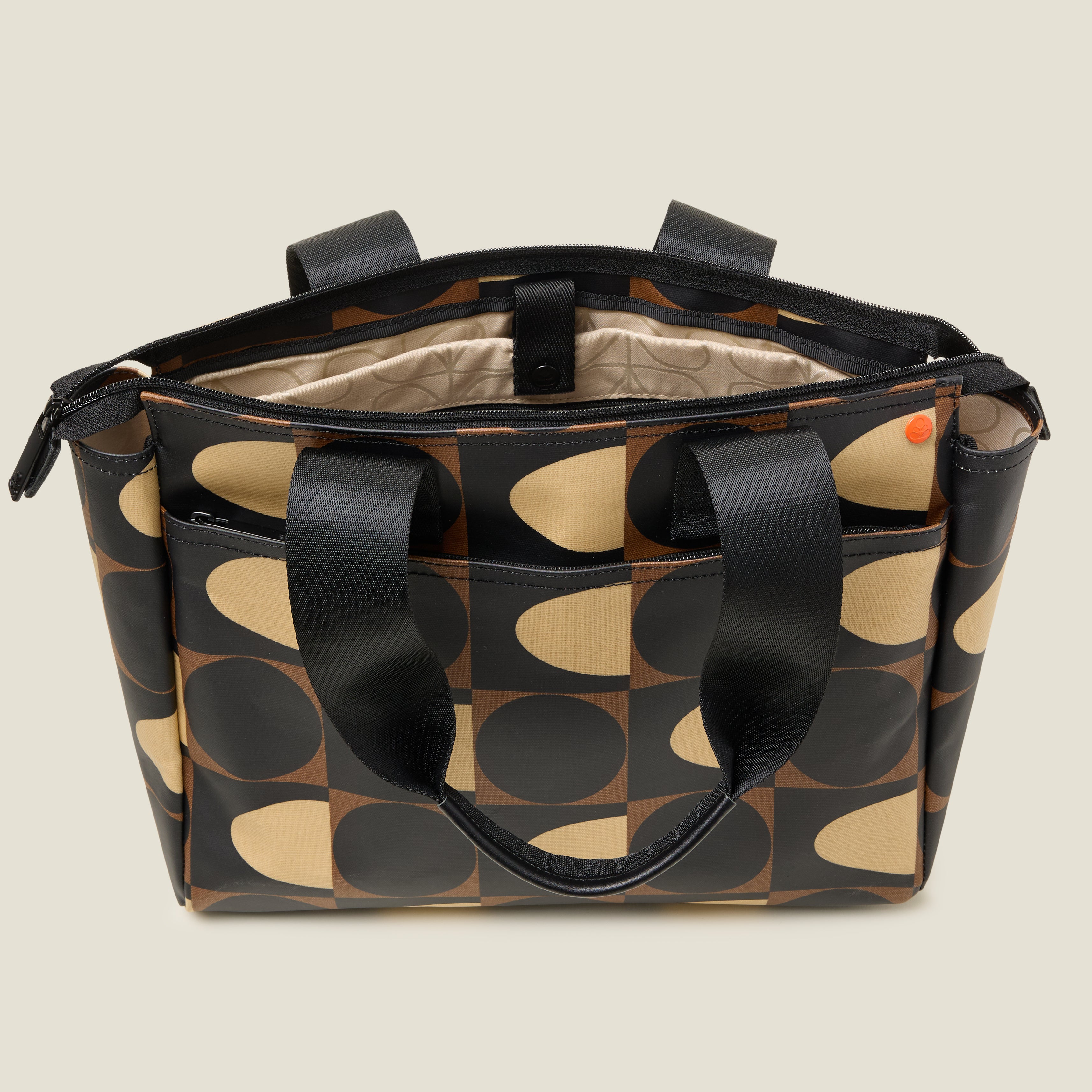 Inside view of a brown, black and cream patterned tote bag with padded laptop sleeve