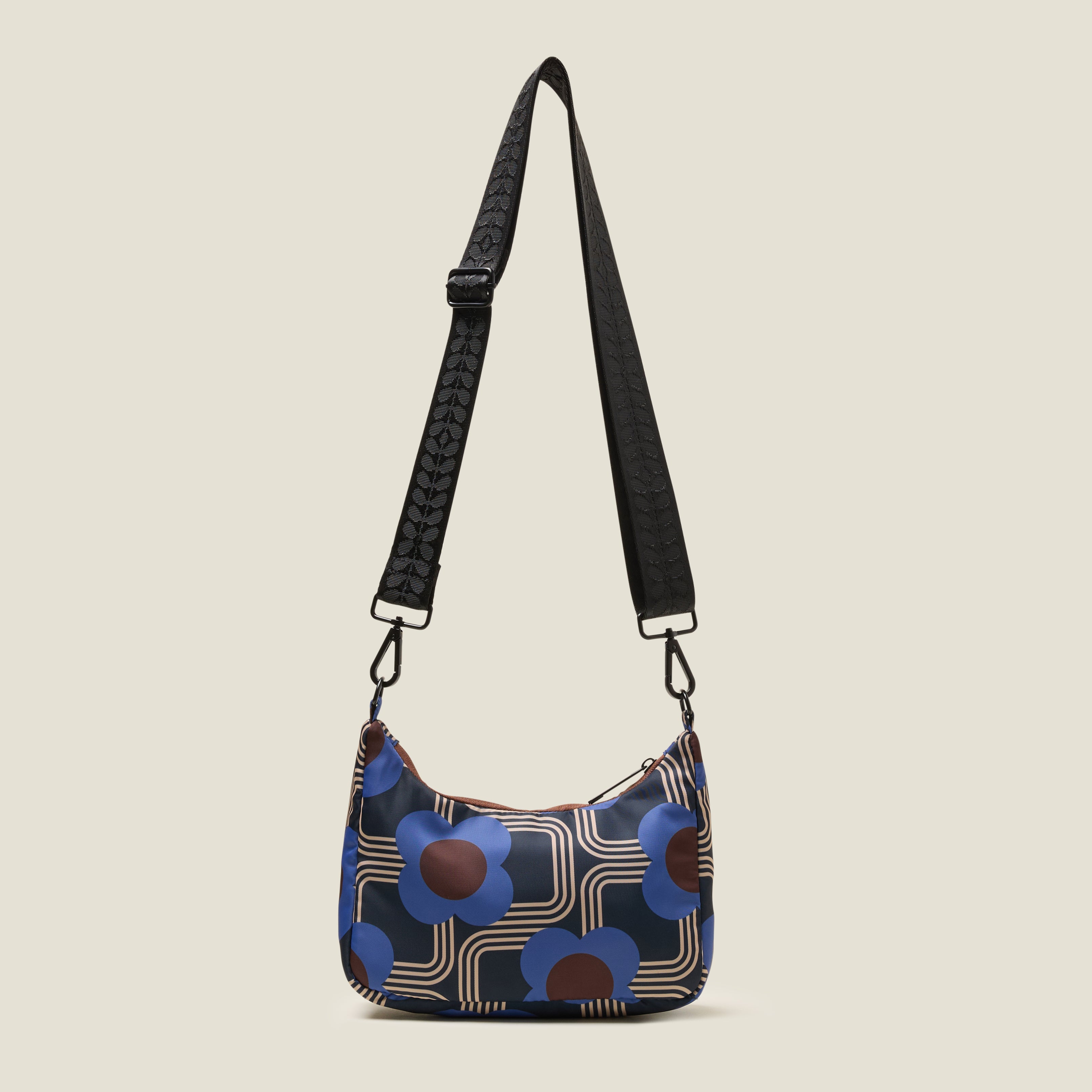 Back view of the Venn handbag with adjuestable cross body strap, featuring electric cobalt blue floral pattern.