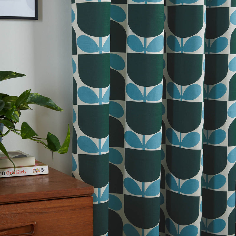 Lifestyle image of Orla Kiely's Block Stem Jade curtains in living room