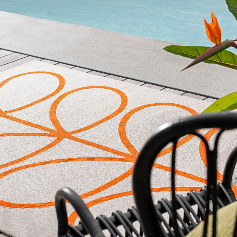 Lifestyle picture of persimmon Orla Kiely stem outdoor rug