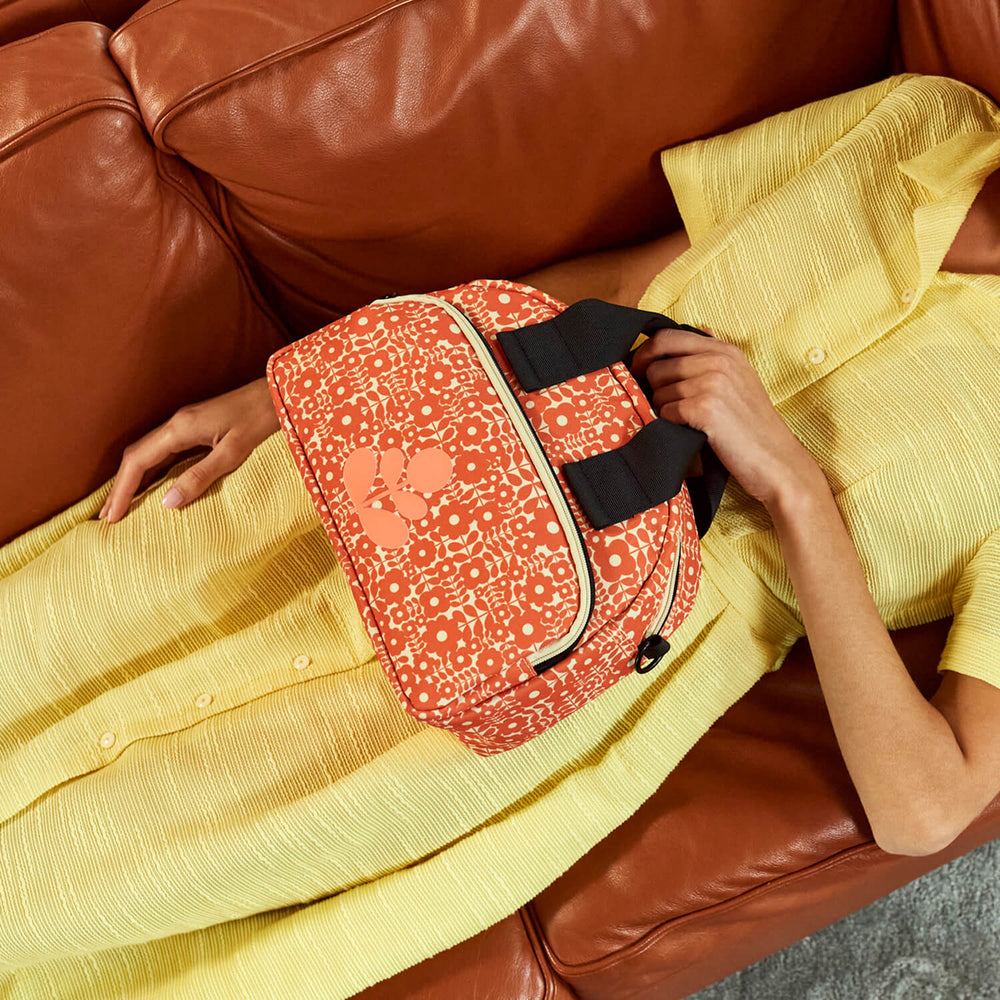 Lying down on a sofa with an Orla Kiely bag 