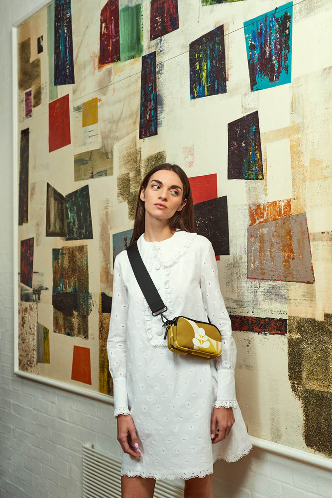 Standing in front of art with a Orla Kiely bag for good