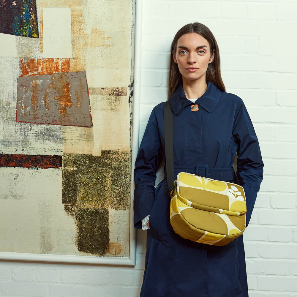 Standing next to a painting with an Orla Kiely bag for good