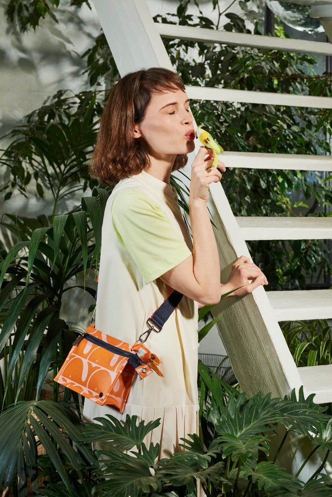 Person with a bird and a beluga Orla Kiely bag