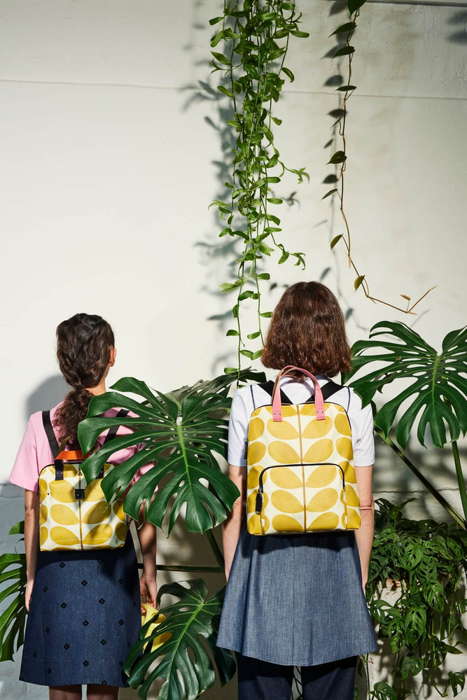 Two people with matching buddy and bestie Orla Kiely sunflower backpacks