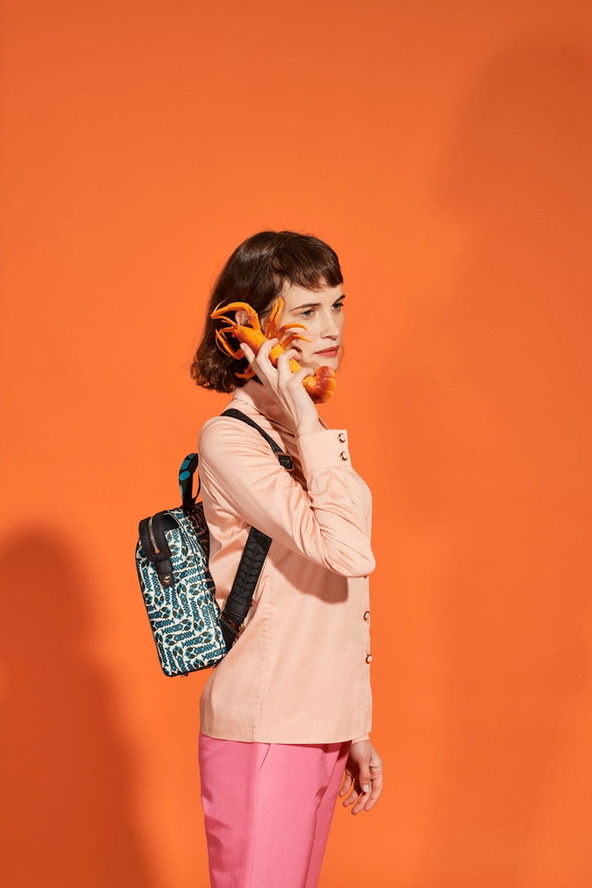 Person on the phone to a lobster whilst wearing an Orla Kiely backpack