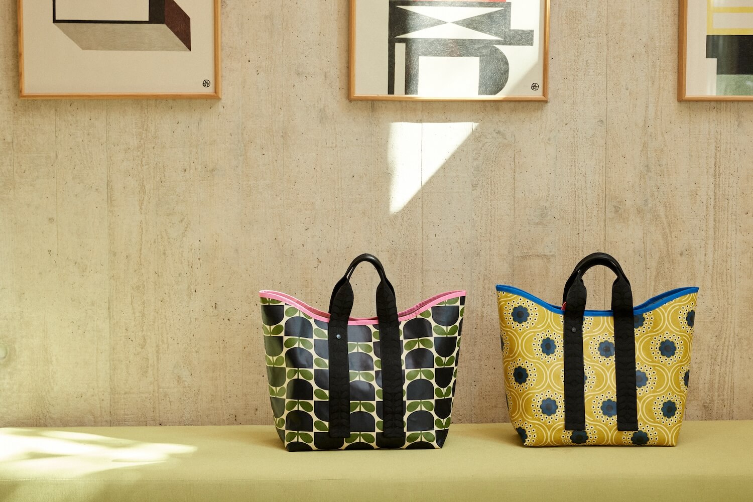 Orla Kiely carrysmall tote bags in front of concrete wall