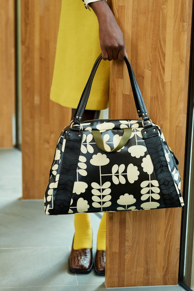 Fielder hold all Orla kiely bag in cut stem in front of wood 