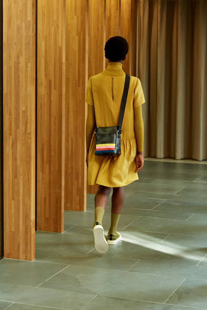 Walking away whilst wearing an Orla Kiely sport ranger bag