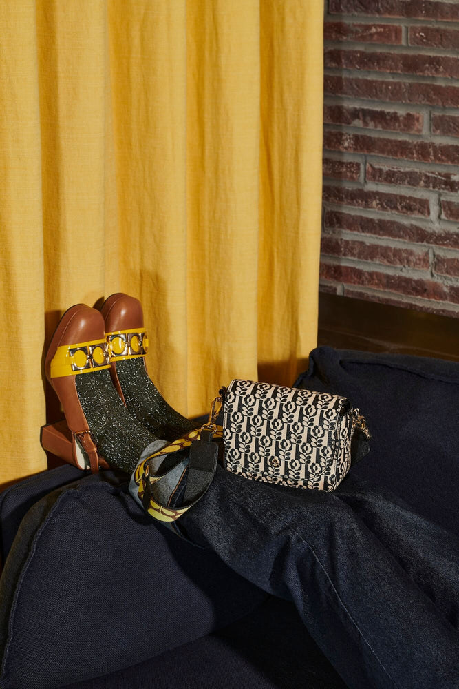 A bark cloth Orla Kiely bag next to some sparkly socks 