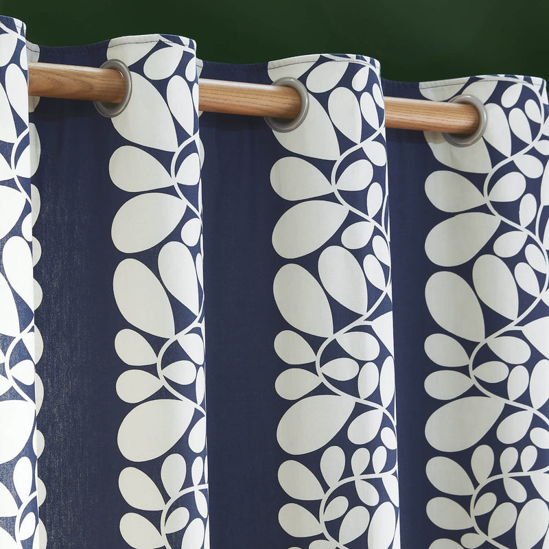 Eyelets of blue Orla Kiely sycamore stem curtains