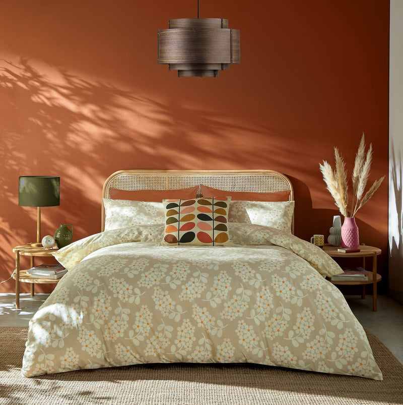 Lifestyle shot of Orla Kiely wisteria bedding and a classic multi stem cushion